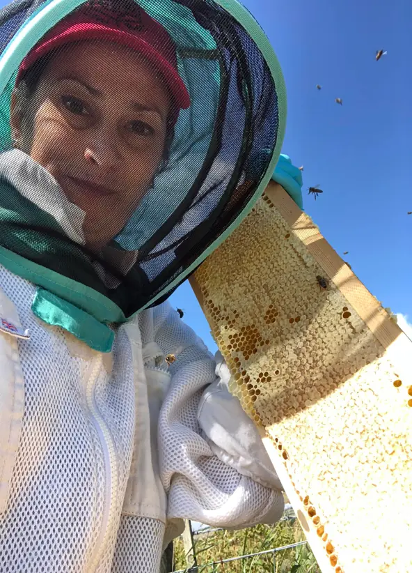 Dani in her  beekeeping suit